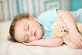 Carefree sleep baby with soft toy on bed Royalty Free Stock Photo