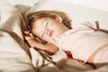 Carefree sleep little baby with a soft toy on the bed. Royalty Free Stock Photo