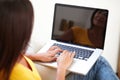 Carefree student working on laptop while sitting