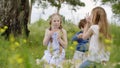 Carefree teenagers eating pizza at green lawn while summer picnic. Teenager girls and boy eating pizza while summer