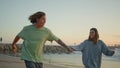 Carefree teens running sand beach having fun at evening. Teenagers ocean date