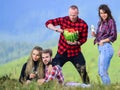 Carefree time with friends. hiking adventure. happy men and girls friends eat watermelon. romantic picnic in tourism Royalty Free Stock Photo