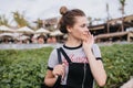 Carefree white girl with brown hair looking away while posing on the street. Outdoor shot of stunning european woman in