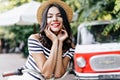 Carefree white girl in summer attire posing on bicycle. Outdoor portrait of magnificent lady in str Royalty Free Stock Photo