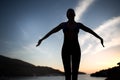 Carefree woman dancing in the sunset on the beach.Vacation vitality healthy living concept