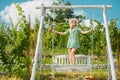 Carefree woman enjoy summer. Gorgeous girl is swinging on a swing and enjoying the beautiful summer weather at nature Royalty Free Stock Photo