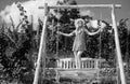 Carefree woman enjoy summer. Gorgeous girl is swinging on a swing and enjoying the beautiful summer weather at nature Royalty Free Stock Photo