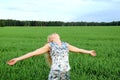 Carefree woman in green field