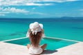 Carefree Woman relaxing in infinity swimming pool looking at vie Royalty Free Stock Photo