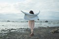 Carefree woman resting and standing on spring sea beach outdoor