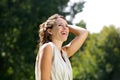 Carefree woman smiling with hand in hair outdoors Royalty Free Stock Photo