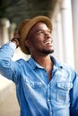 Carefree young african american man smiling with hat Royalty Free Stock Photo