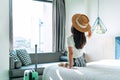 Carefree young Asian traveler female relax on bed in hotel room. Travel alone, summer , vacation concept. Copy space Royalty Free Stock Photo