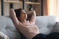 Carefree young beautiful housewife napping on couch. Royalty Free Stock Photo