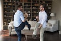 Carefree young brothers dancing in modern living room