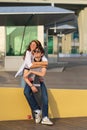 Carefree young couple has fun: girlfriend piggybacking boyfriend. Lovers girl and guy skateboarders Royalty Free Stock Photo