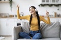 Carefree Young Indian Woman In Wireless Headphones Listening Music At Home Royalty Free Stock Photo