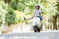 Carefree young man driving scooter Royalty Free Stock Photo