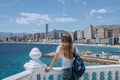 Carefree young tourist woman in sun hat enjoying sea view at Balcon Royalty Free Stock Photo