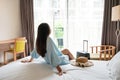 Carefree young traveler woman relax on bed in hotel room. Travel alone, summer weekend concept Royalty Free Stock Photo