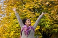 Carefree young woman enjoying autumn with arms raised Royalty Free Stock Photo