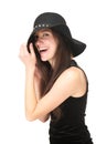 Carefree young woman laughing with black hat Royalty Free Stock Photo