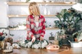 Attractive young woman florist around flowers