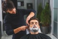 Careful barber serving his client Royalty Free Stock Photo