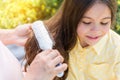 Careful expectant mother combing hair of girl Royalty Free Stock Photo