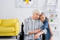 Careful girl embracing granny in wheelchair