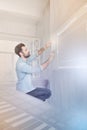 Young man carefully touching a security system while being in smart house