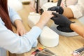 Careful master of manicure in black gloves begin to make manicure