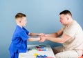 Careful pediatrician check health of kid. Medical examination. Medical service. Man doctor sit table medical tools Royalty Free Stock Photo