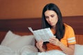 Woman Reading Medicine Leaflet Before Taking Pills