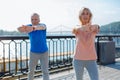 Elderly couple warming up before jogging Royalty Free Stock Photo