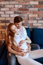 Careful responsive man stroke pregnant belly of wife Royalty Free Stock Photo