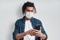 Careful young African man wearing medical face mask Royalty Free Stock Photo