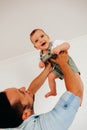 Careful young father playing with his little cute baby boy. Royalty Free Stock Photo