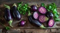 A carefully arranged composition of whole and sliced eggplants on a rustic wooden table Royalty Free Stock Photo
