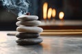 A carefully arranged stack of smooth zen stones rests on a table, surrounded by the gentle smoke from burning incense Royalty Free Stock Photo
