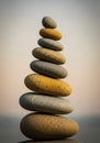 A carefully balanced stack of smooth pebbles, varying in color from gray to golden Royalty Free Stock Photo