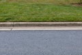 Carefully edged grass alongside extruded concrete curbing and asphalt street, creative copy space options