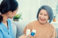 Caregiver advising contented senior woman on medication in the living room. Royalty Free Stock Photo