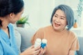 Caregiver advising contented senior woman on medication in the living room. Royalty Free Stock Photo