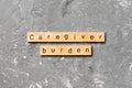 Caregiver burden word written on wood block. Caregiver burden text on cement table for your desing, concept Royalty Free Stock Photo