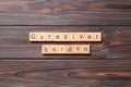 Caregiver burden word written on wood block. Caregiver burden text on cement table for your desing, concept Royalty Free Stock Photo