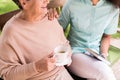 Caregiver caring about female pensioner Royalty Free Stock Photo