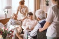 Young caregiver comforting elderly woman in nursing home Royalty Free Stock Photo