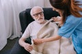 Caregiver covering senior patient Royalty Free Stock Photo