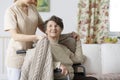 Caregiver covering senior woman with a blanket Royalty Free Stock Photo